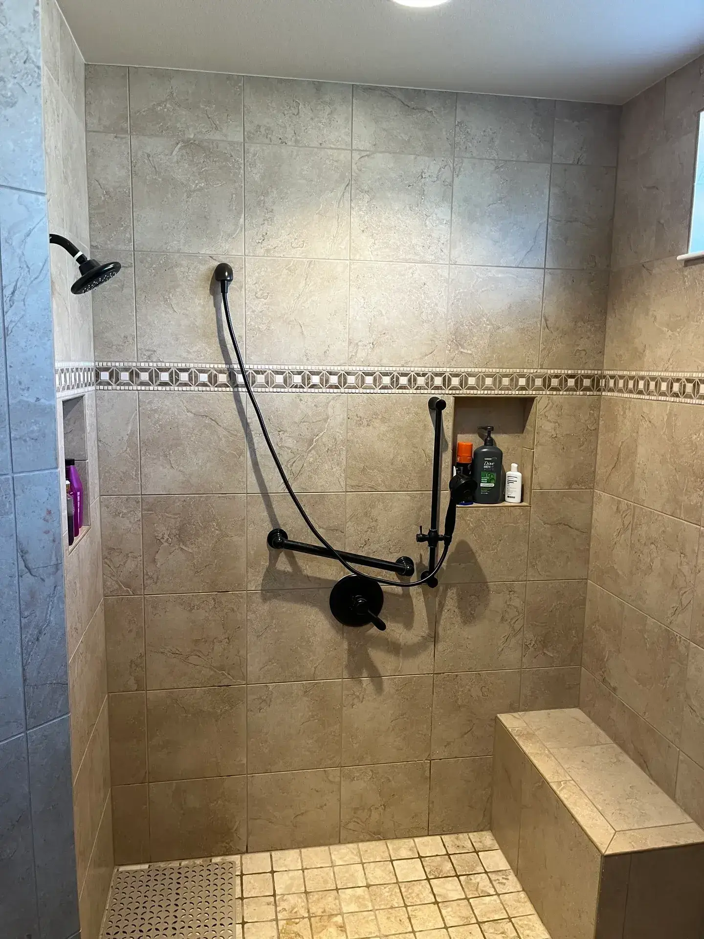Tiled shower with bench and black fixtures