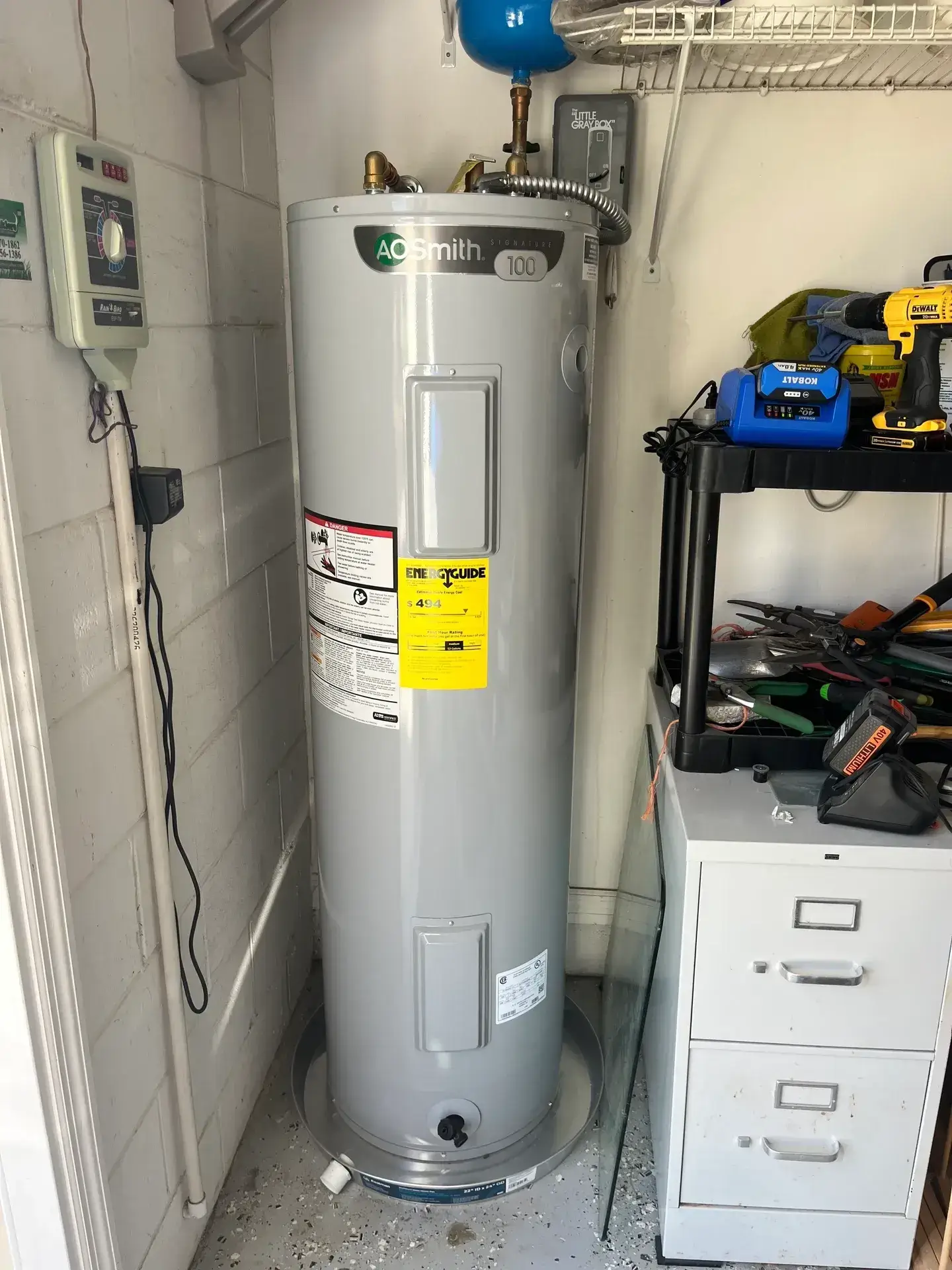 Tall gray water heater in utility room