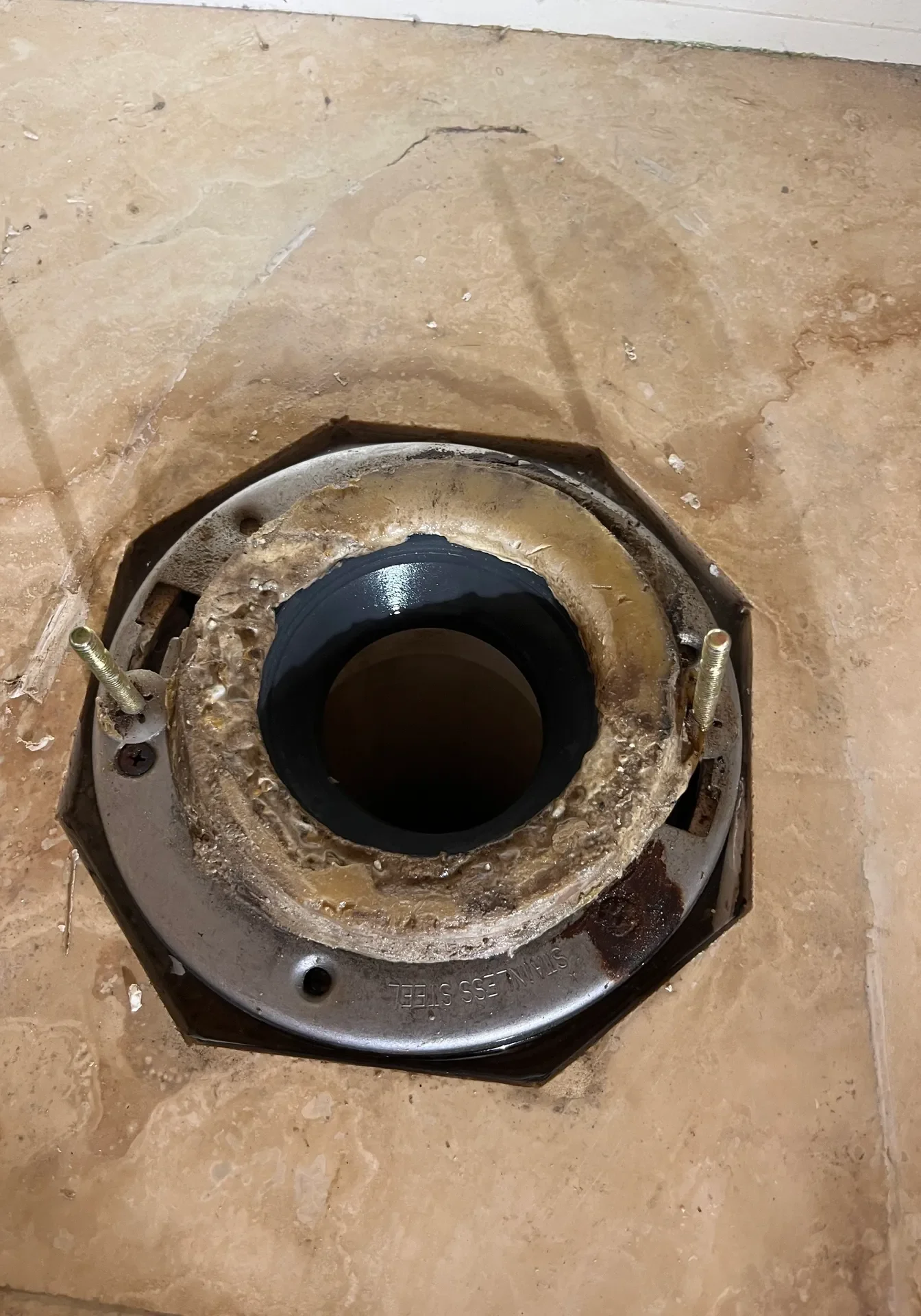 Rusty circular metal part with a central hole on cardboard.